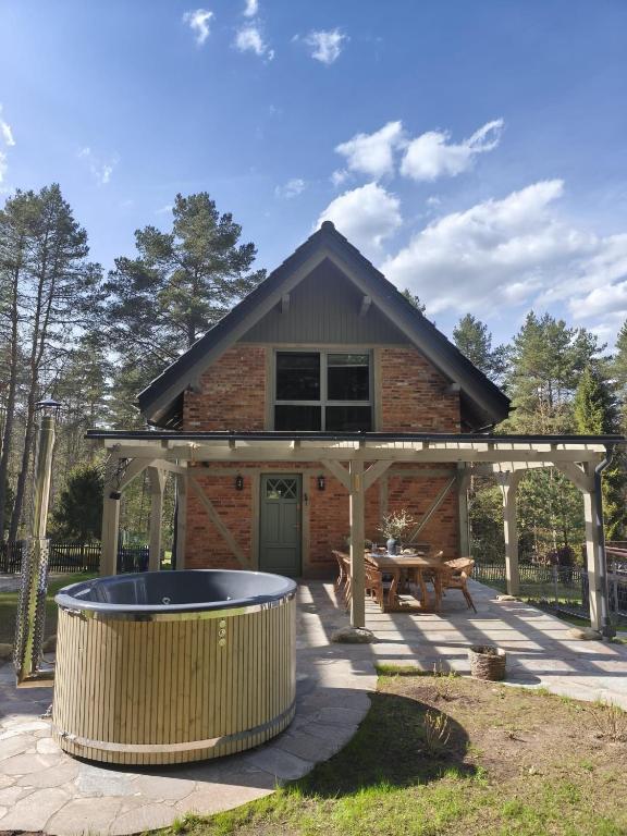 a house with a hot tub in front of it at Dublinkowo in Gołubie