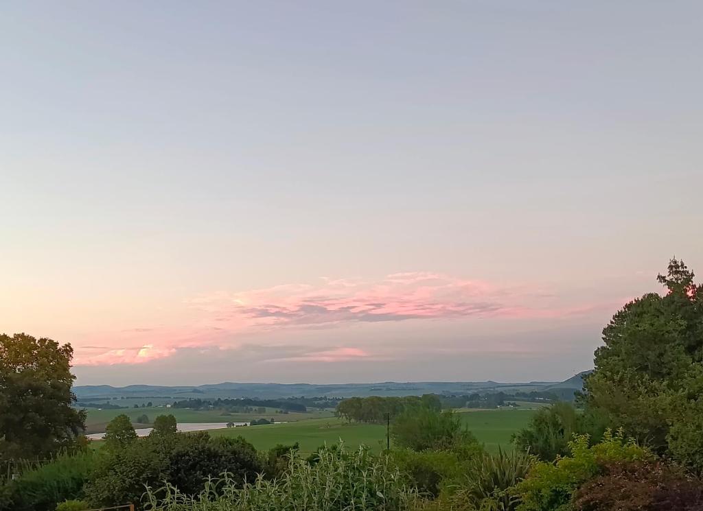 a view from the top of a hill at sunset at Valley View the home with a view in Nottingham Road