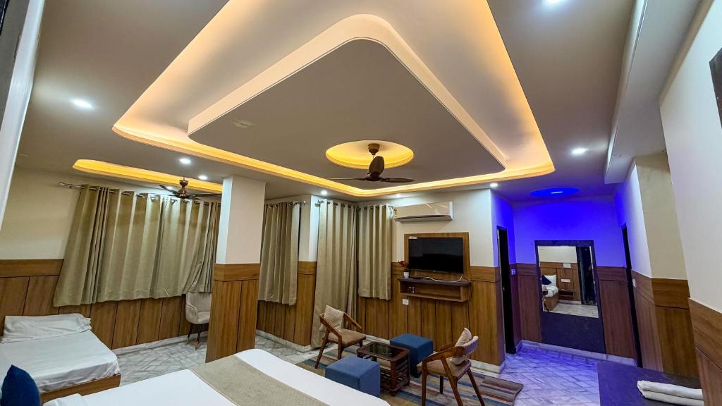 a hotel room with a bed and a tv at Sumitra Enclave in Jaipur