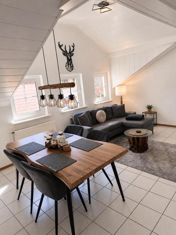 a living room with a table and a couch at Apartment Auszeit in Ulrichstein