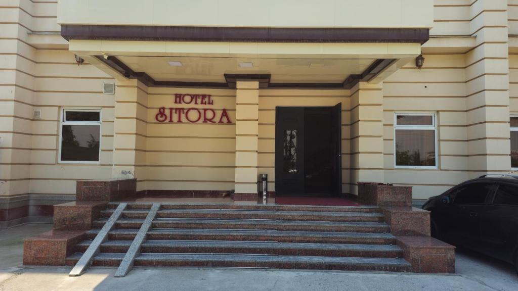 a front of a building with a door at Sitora in Chirchiq
