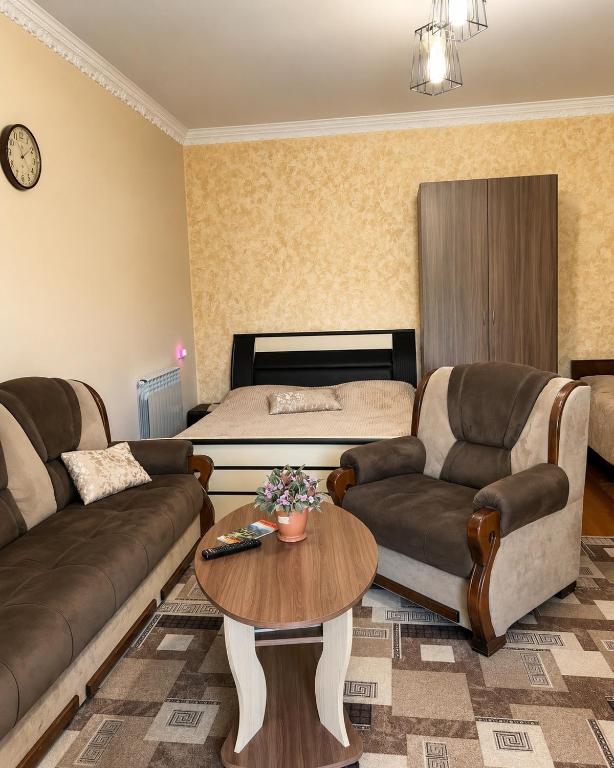 a living room with a couch and a bed at Norik guest house in Garni