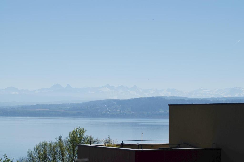 a view of a large body of water from a building at L'Effet Papillon - Maison d'hôtes in Sauges