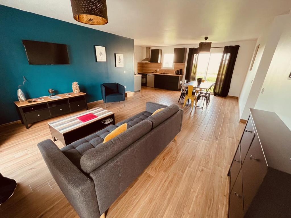 a living room with a couch and a table at Villa Alba in Auménancourt-le-Petit