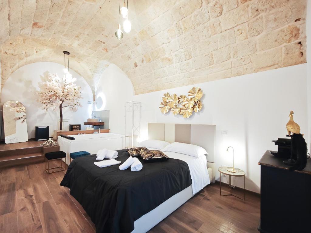 a bedroom with a bed with two towels on it at Olympus Luxury Suites Menotti in Mola di Bari