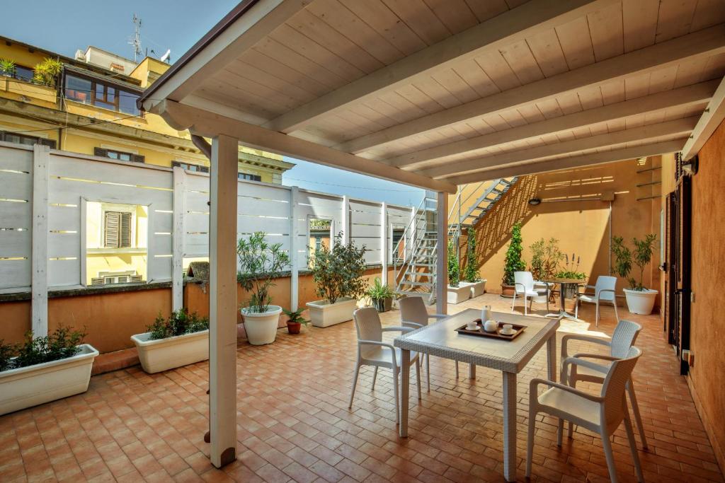 a patio with a table and chairs on a balcony at Rooftop St. Peter in Rome