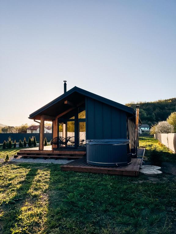 a small blue building on a grass field at Zarichna Cottage in Podgorodtsy