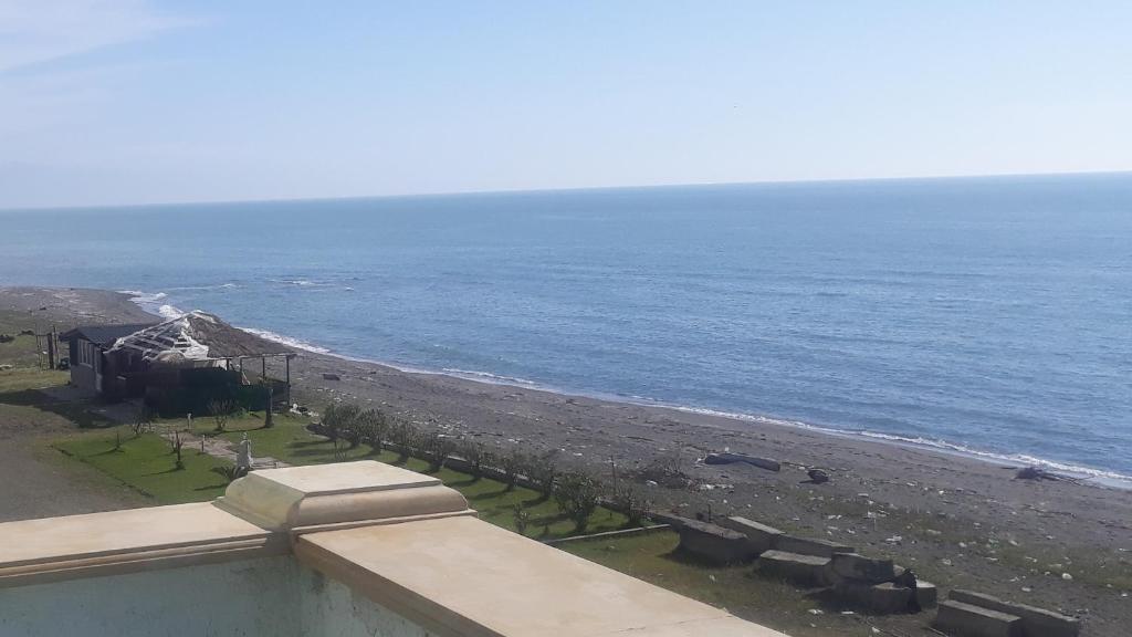 a view of the beach from the balcony of a house at Hotel Marina in Shekhvetili