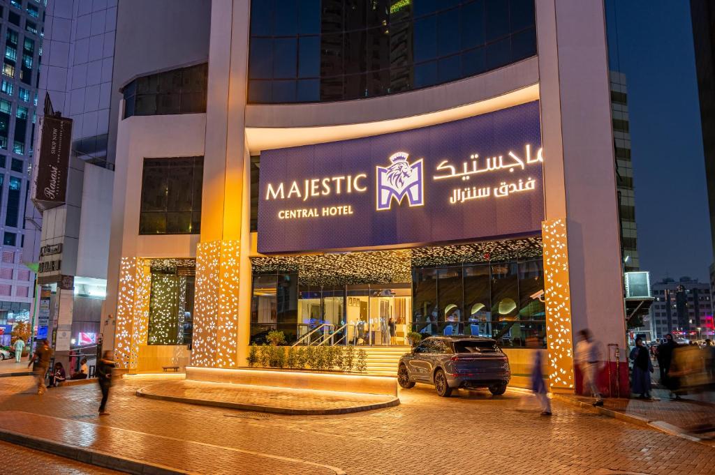 a large building with a car in front of it at Majestic Central Hotel in Dubai