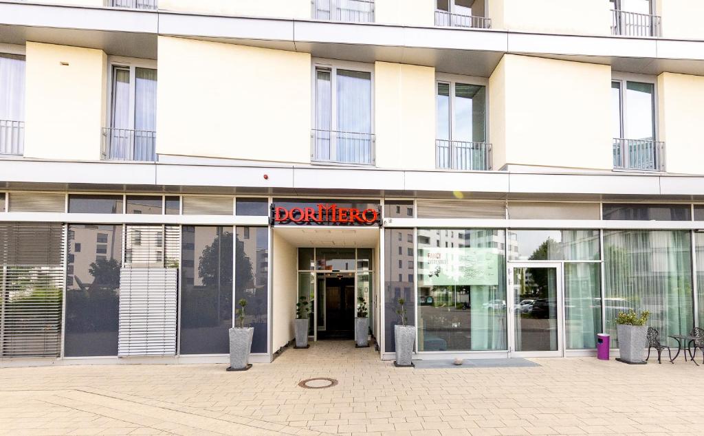 a large white building with a sign that reads berkeley at DORMERO Hotel Freiburg in Freiburg im Breisgau