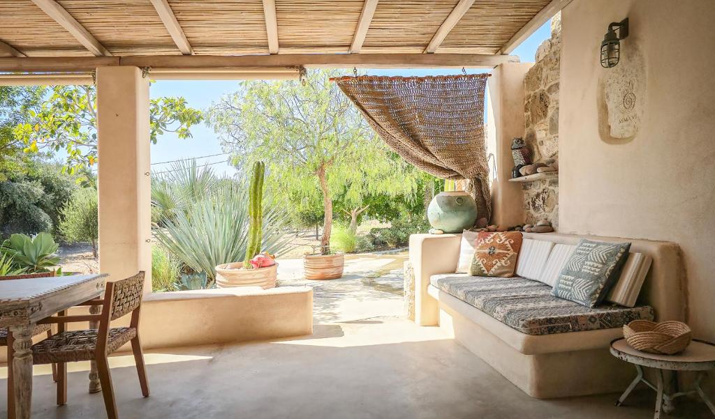 a living room with a couch and a large window at Hamilton - Sohoros in Kámpos
