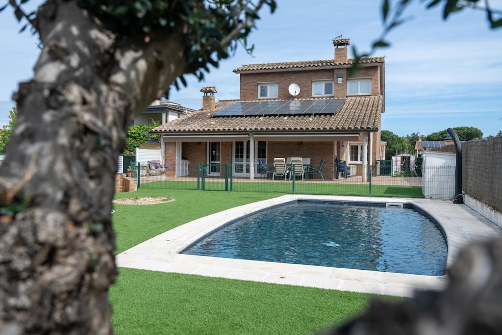 a house with a swimming pool in front of a house at Luxury Getaway in Girona in Riudellots de la Selva