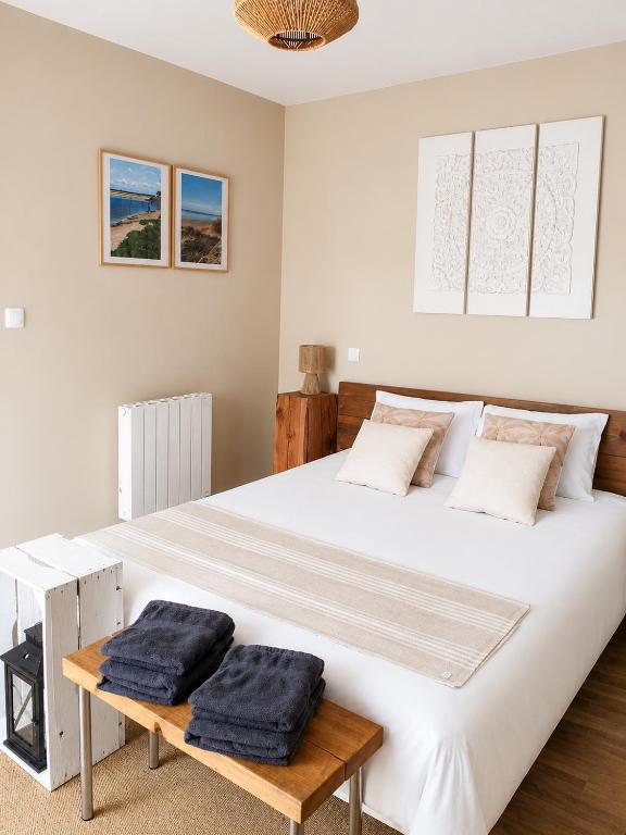 a bedroom with a large white bed with two pillows on it at Chez Elise et Joseph in Mons-Boubert