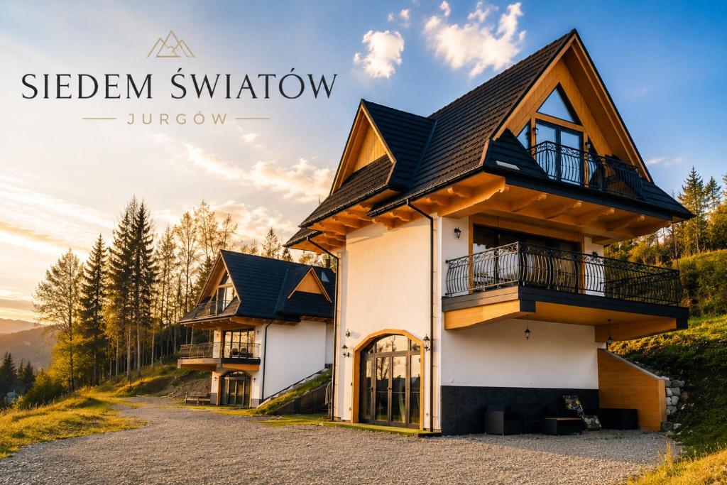 a house on a hill with the words sleben window junatown at Siedem Światów Domek in Jurgów