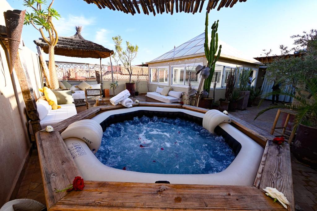 a hot tub in the middle of a patio at Riad MISS CARACAL Jacuzzi & Rooftop in Marrakesh