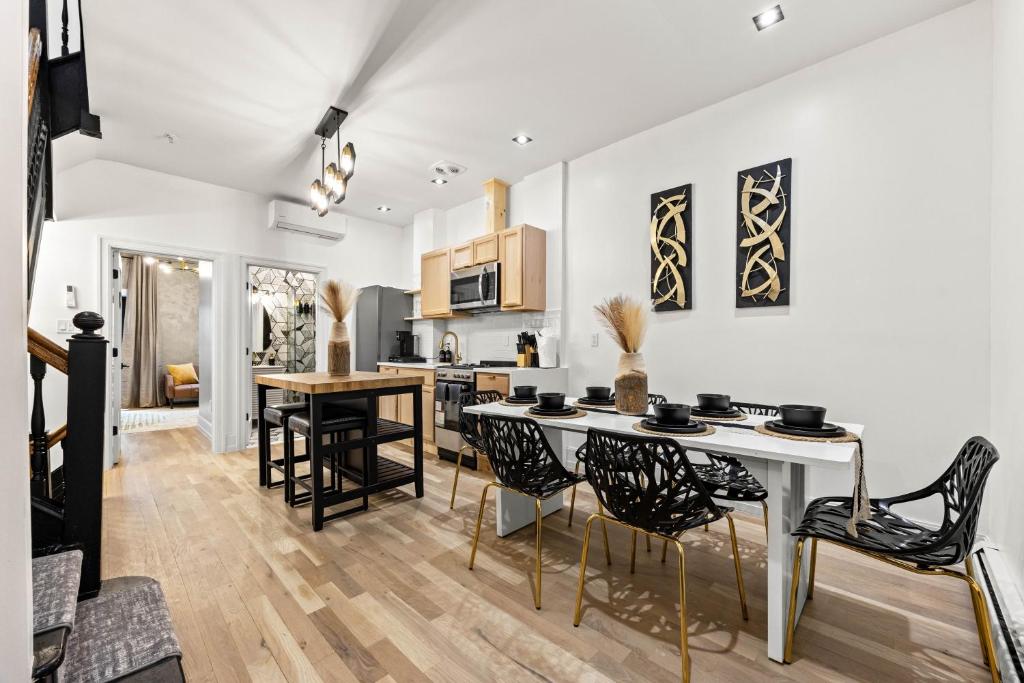 a kitchen and dining room with a table and chairs at The West 142nd Street Apartments - Manhattan NYC in New York