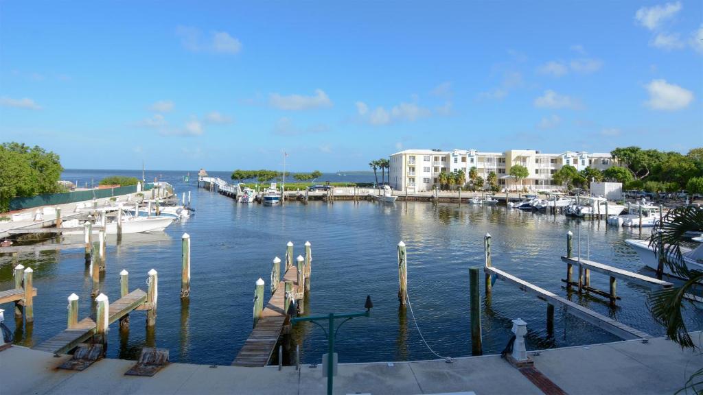 a marina with a dock and boats in the water at 122 Mariners Club in Key Largo