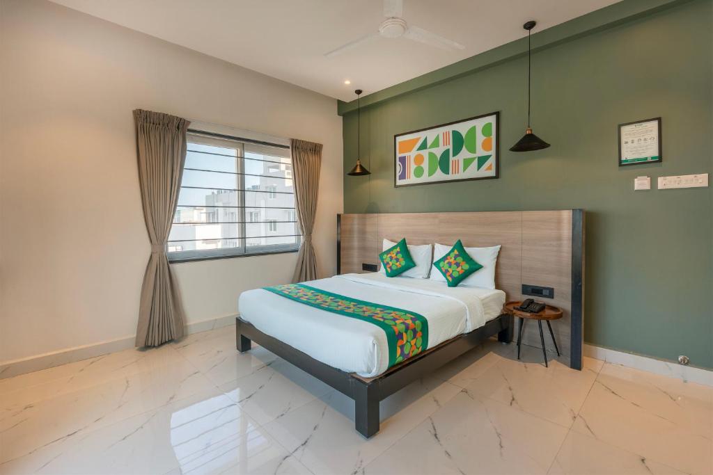 a bedroom with a bed and a window at Treebo Premium Vapr Ashok Nagar in Chennai