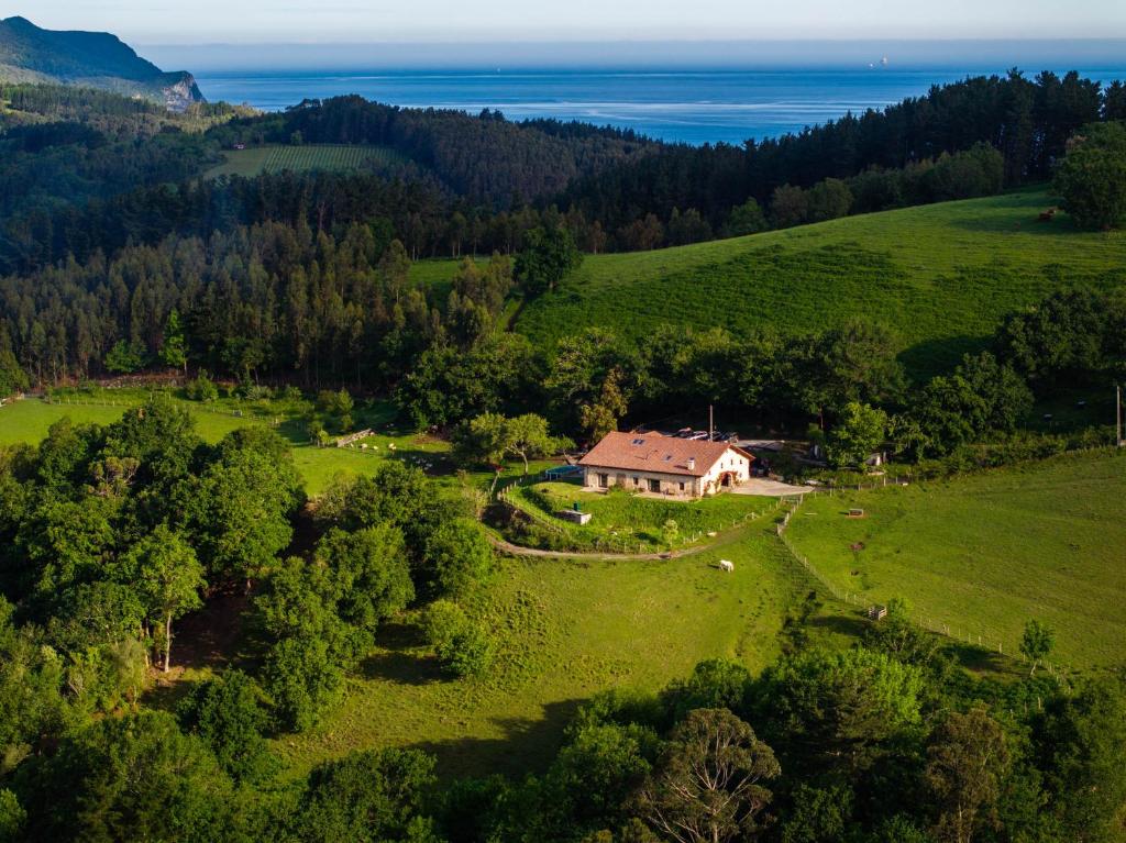an aerial view of a house in a green field at Olabe hostel in Ea