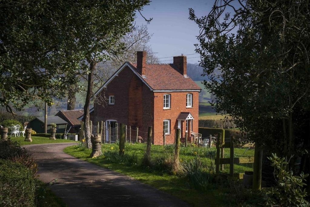 an old brick house on the side of a road at Foxhill House in Ledbury