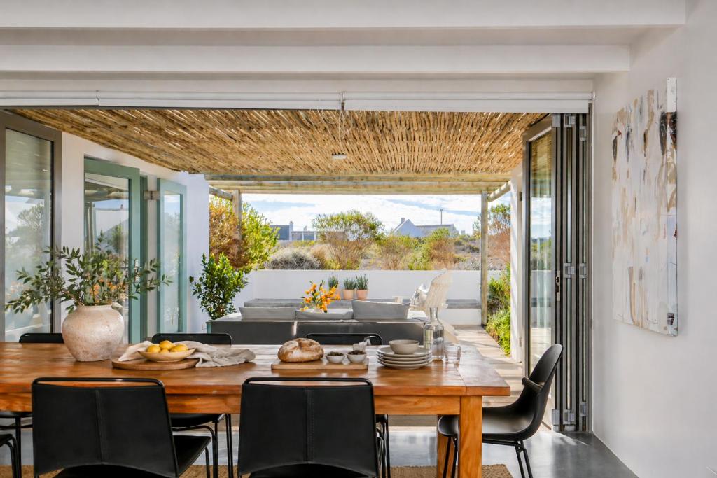 a dining room with a table and chairs at The Cottage Collection Paternoster in Paternoster