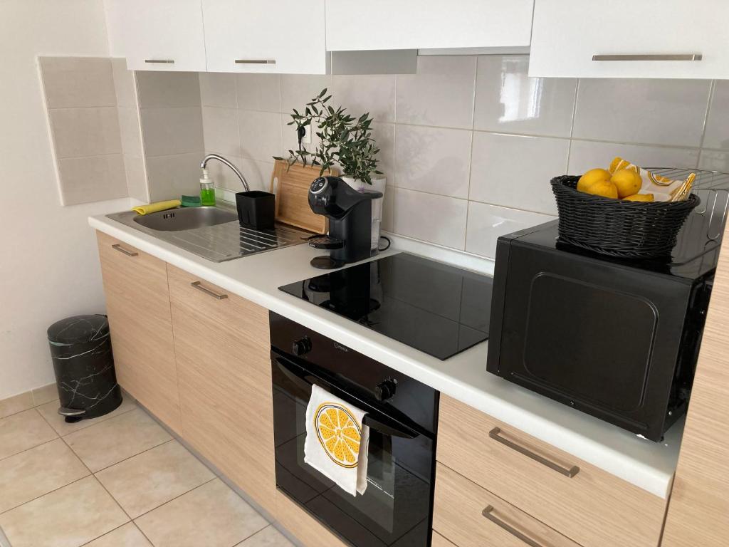 a kitchen with a sink and a stove top oven at Lorenzo apartment in Milna