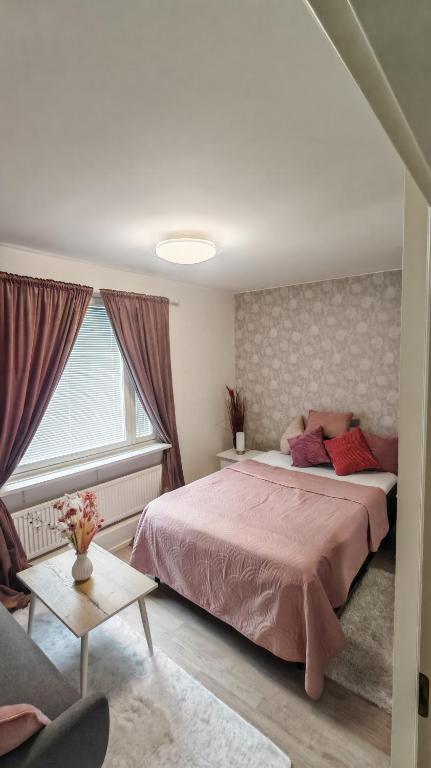 a bedroom with two beds and a window at SEA - 3 Bedrooms in Kristinestad