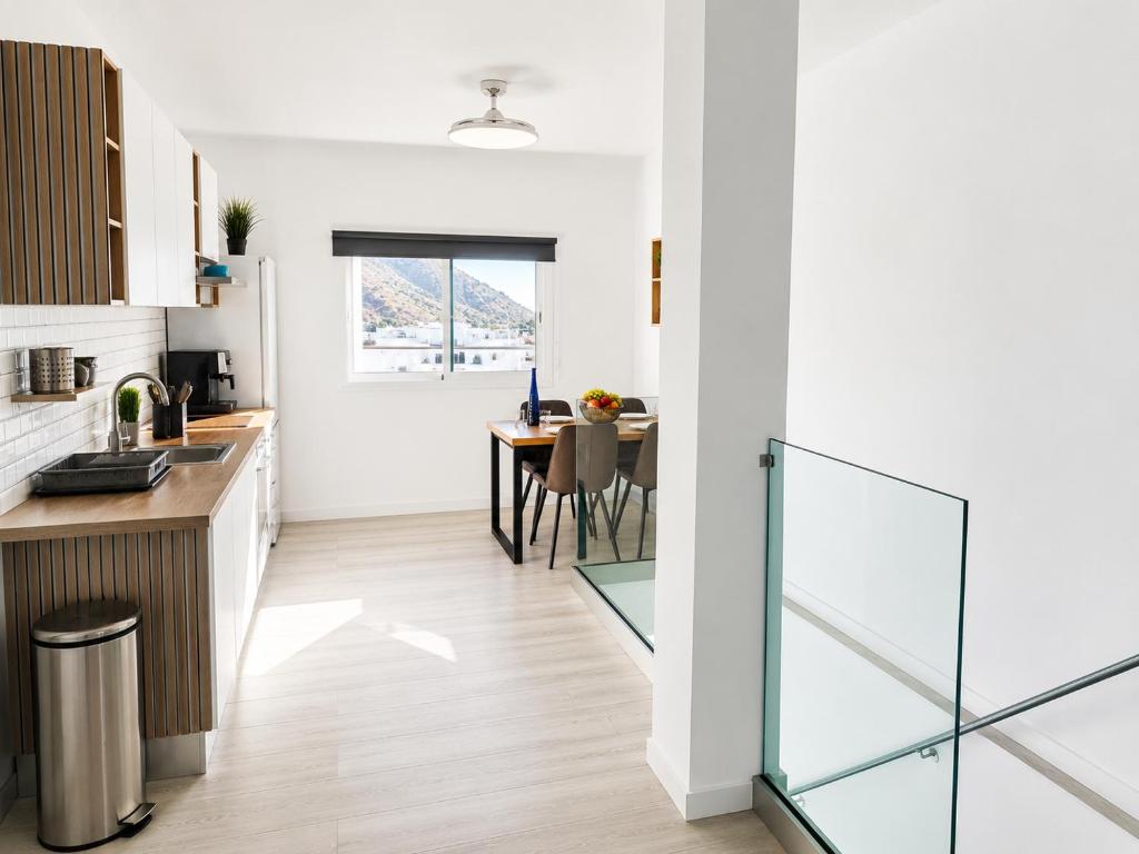 a kitchen and dining room with a table at Noalys Entre Mar y Valle in Agaete
