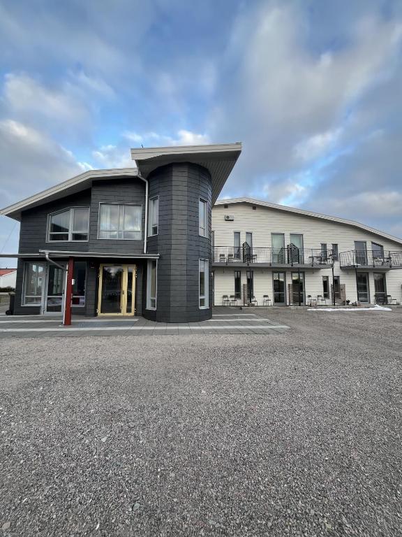 a large building with a roof on a street at Hotell Vänersborg in Vänersborg