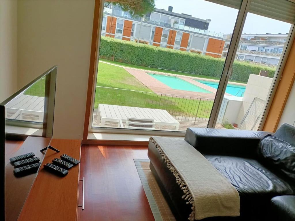 a living room with a couch and a large window at Pacos Beach House in Lavra