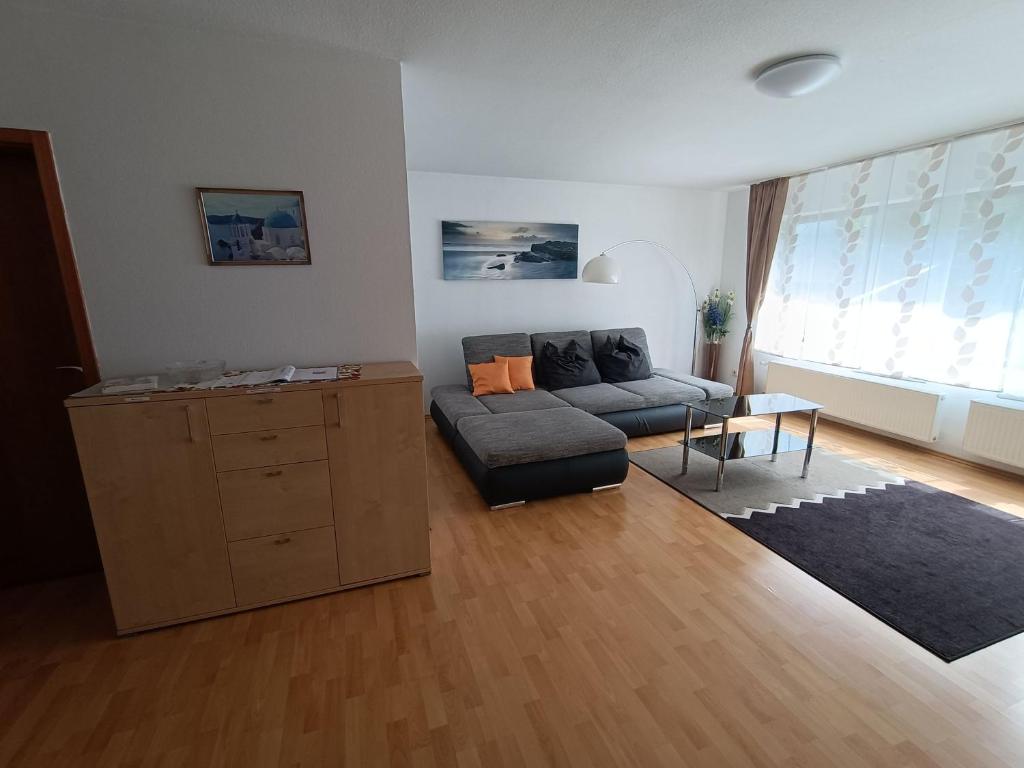 a living room with a couch and a table at Ferienwohnung Notos- Eislingen in Eislingen