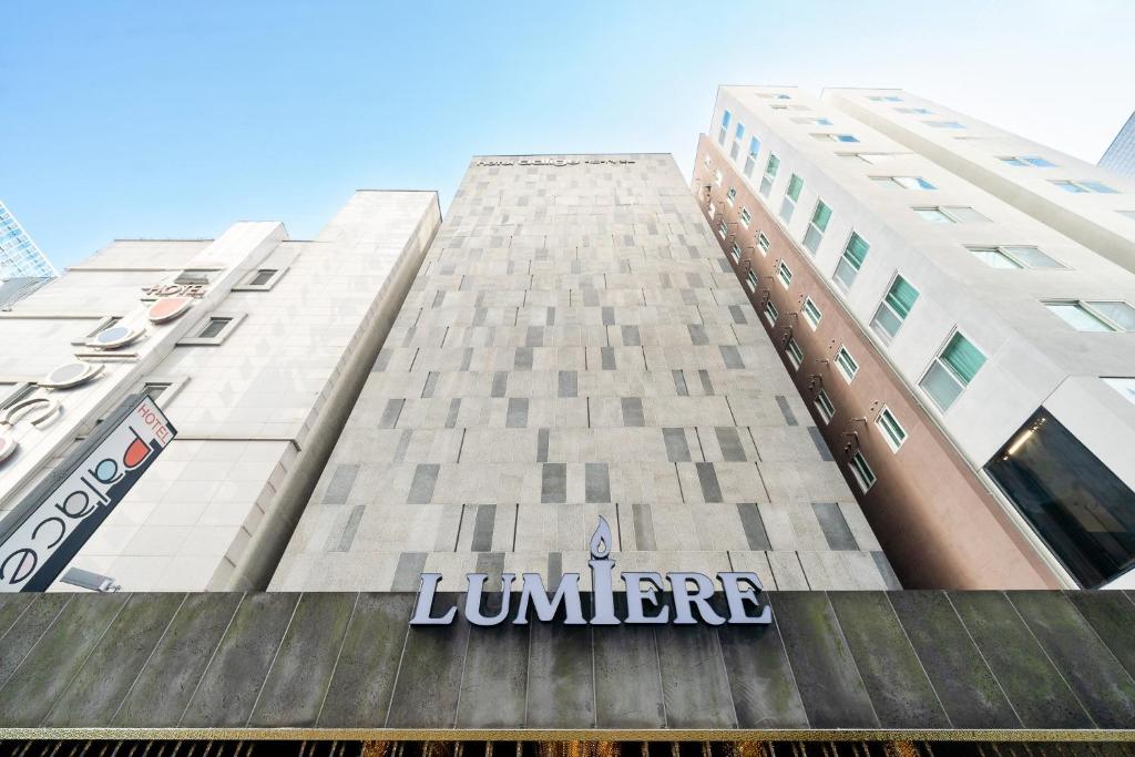 a building with a sign on the side of it at Yeoksam Lumiere Hotel in Seoul