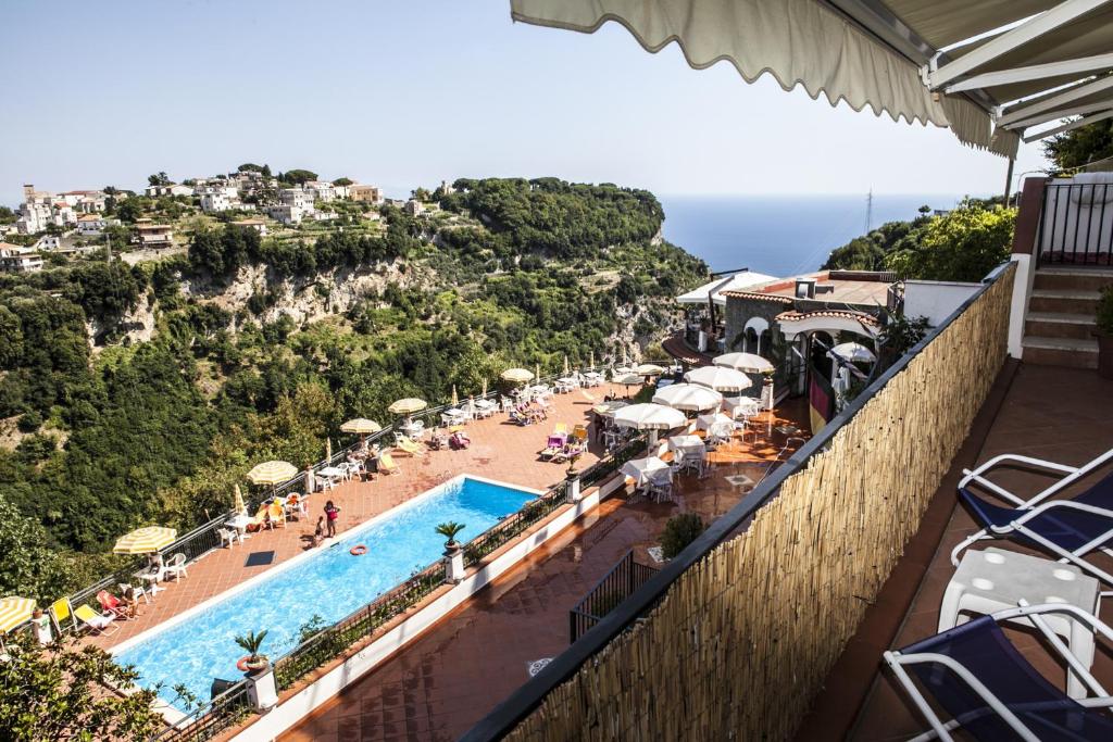 a view of a resort with a pool and a beach at The Loft Via Torricella in Ravello