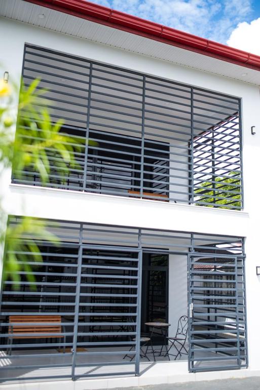 a building with a large window with blinds on it at Bantaskine Apartments in Paramaribo