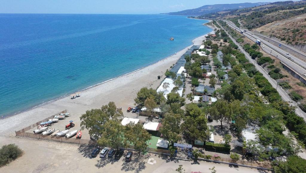 an aerial view of a beach with trees and a road at Campeggio Il Delfino in Rocca Imperiale