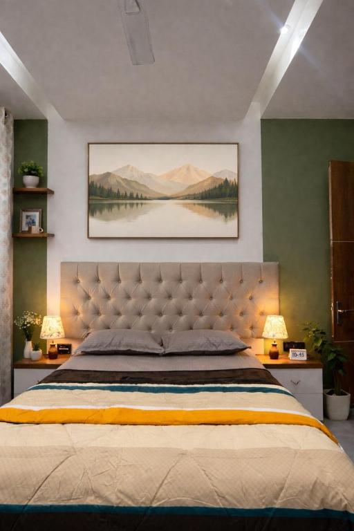 a bedroom with a large bed with two lamps at The Social Haven - Your Emerald Executive in Noida