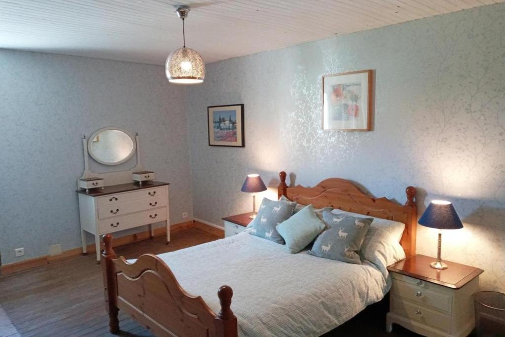 a bedroom with a bed and a dresser and a mirror at Cottage Sleeps 2- Pet Friendly WiFi Free Parking in Montauriol