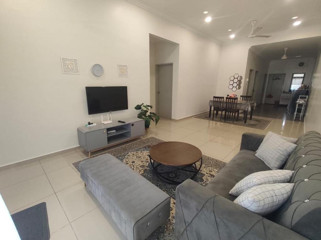 a living room with a couch and a tv at AA Homestay Bandar Mahkota Banting in Banting