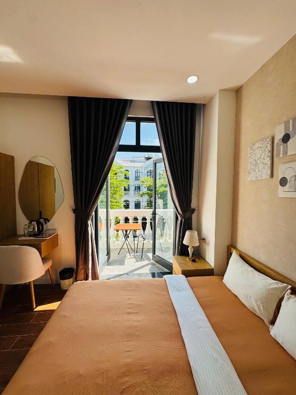 a bedroom with a large bed and a large window at StayLa Homestay Grand World Phu Quoc in Phú Quốc