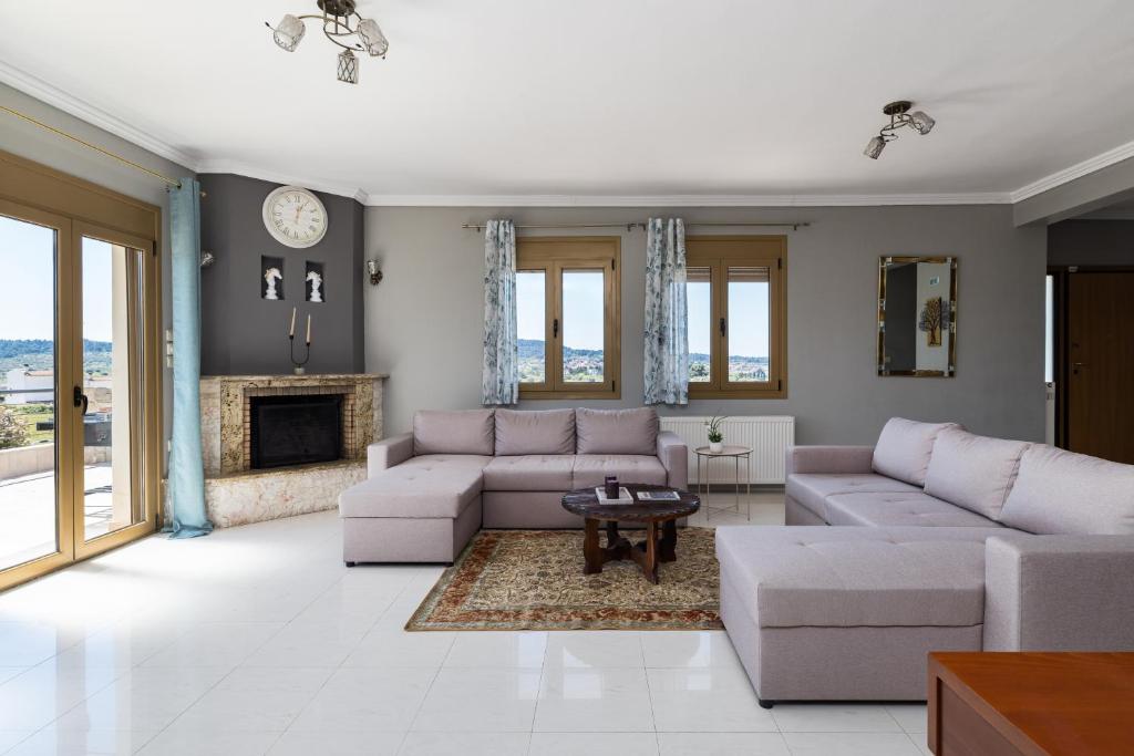 a living room with couches and a fireplace at Villa Granero by Booking Kottas in Kassandra