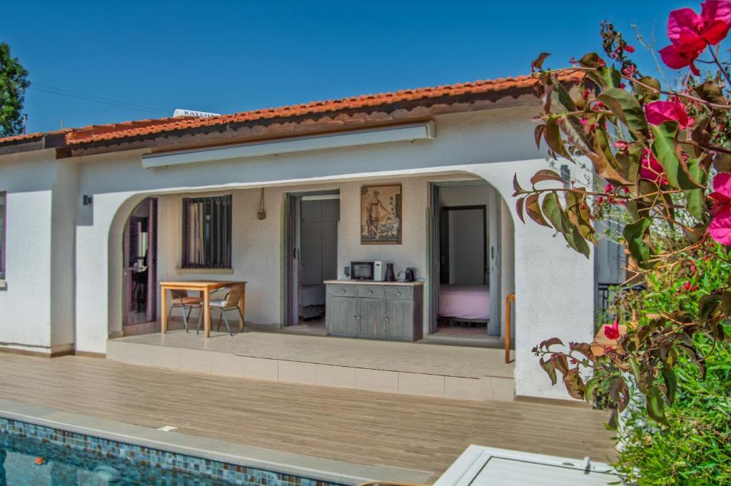 a villa with a swimming pool and a house at Villa Leda - The Guest Wing in Paphos