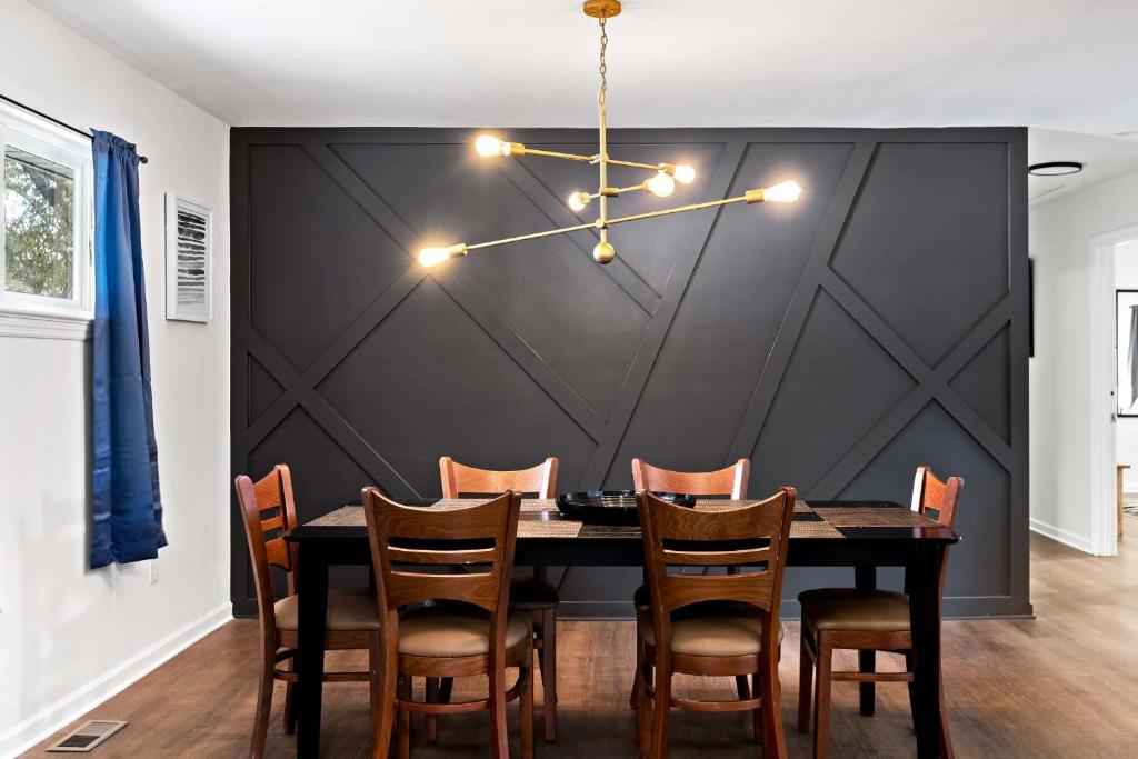 a dining room with a table and chairs at Mins to Downtown Chic & Modern - Elegant in Noir in Chattanooga