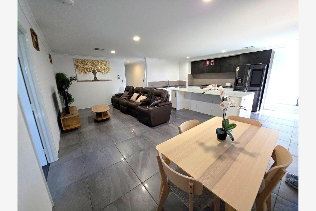 a living room and kitchen with a table and a couch at Baldivis Retreat in Baldivis