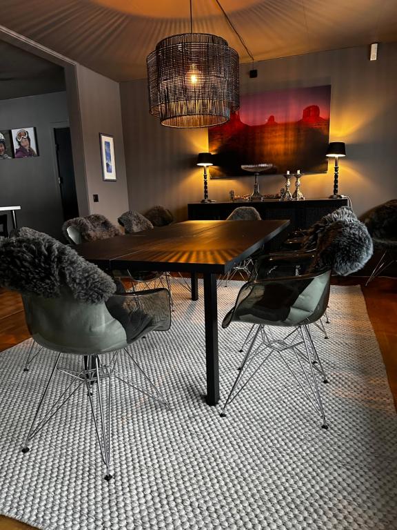 a dining room with a wooden table and chairs at Spacious Hemsedal villa with mountain views in Hemsedal
