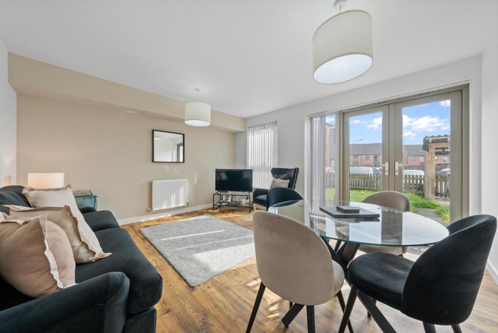 a living room with a couch and a table and chairs at Castle View in Stirling