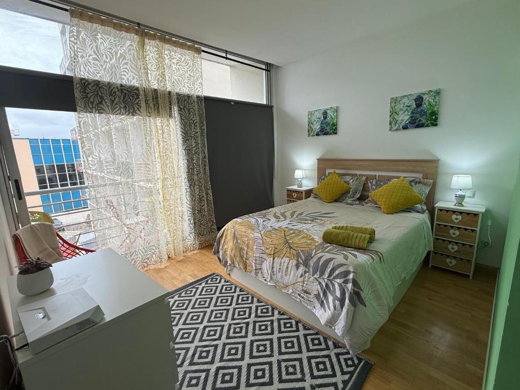 a bedroom with a bed and a large window at Villaverde light & terrace in Madrid
