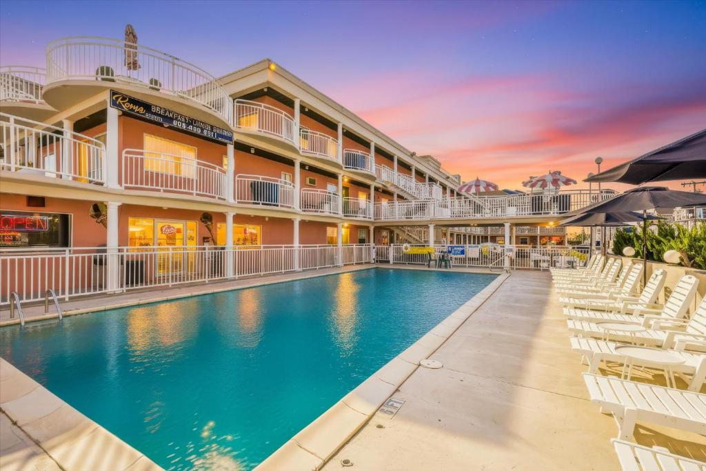 a swimming pool in front of a building with a resort at Coliseum Ocean Resort in Wildwood Crest