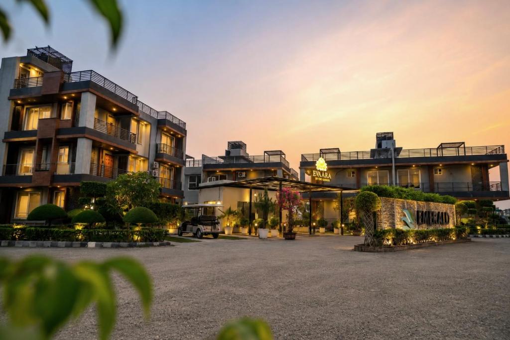 a large building with a courtyard in front of it at Evaara By The Ganges A Ganga Access Resort & Jungle Safari in Haridwār