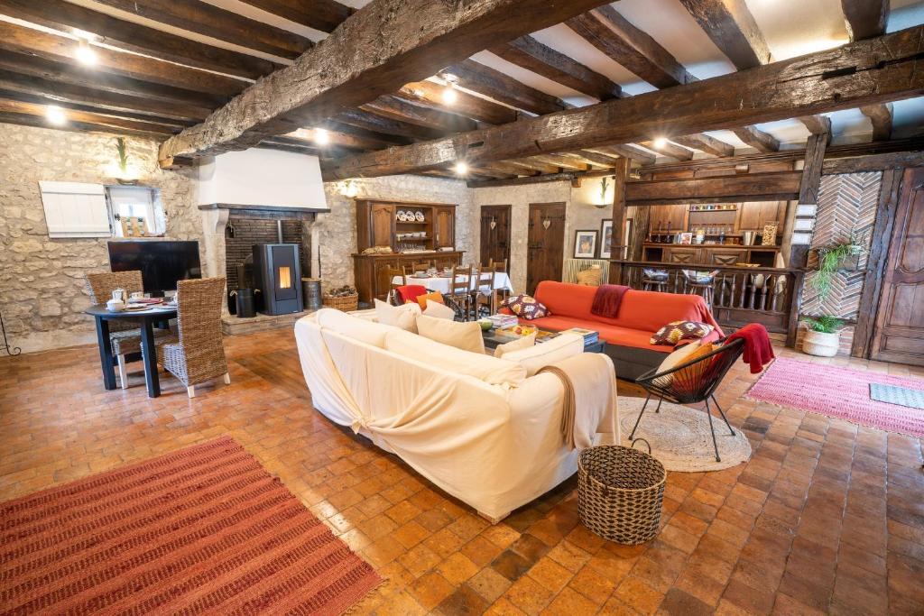 a living room with a couch and a table at LA CORMELLERIE in Saint-Ay
