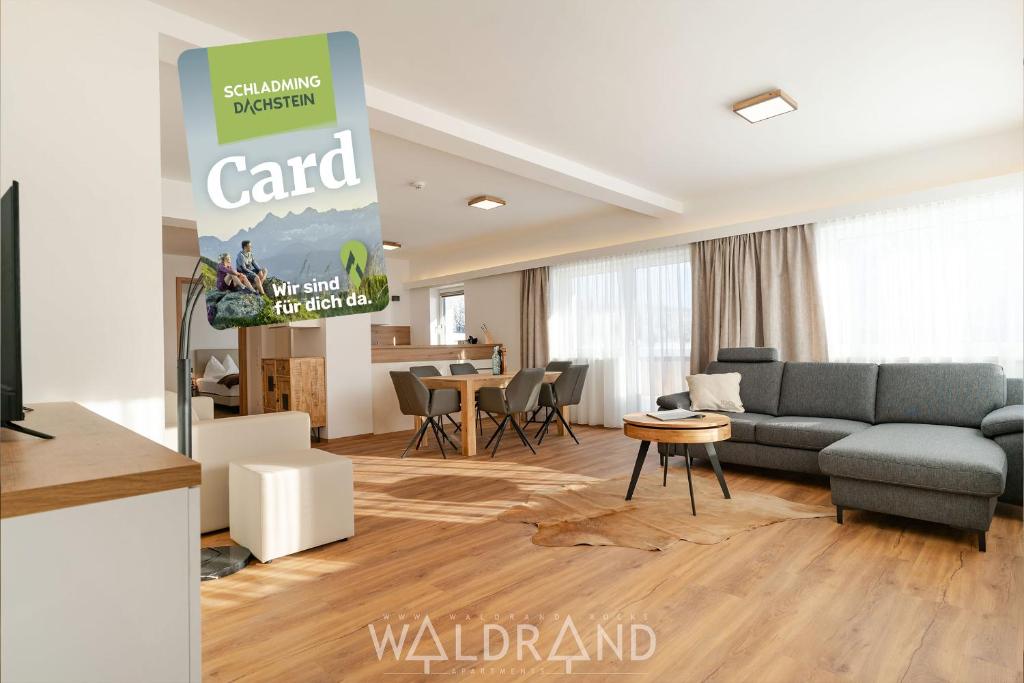 a living room with a couch and a table at Waldrand Apartments - by myNests in Ramsau am Dachstein